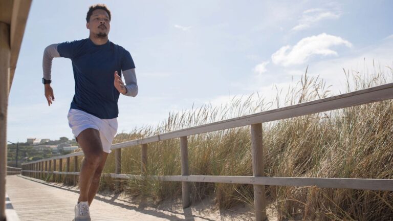 Distance runner wearing fitted moisture-wicking shorts and running clothing during a warm-weather workout.