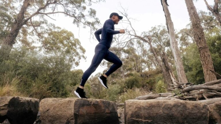 Trail runner maintaining a relaxed conversational pace during an easy aerobic run on a forest trail.